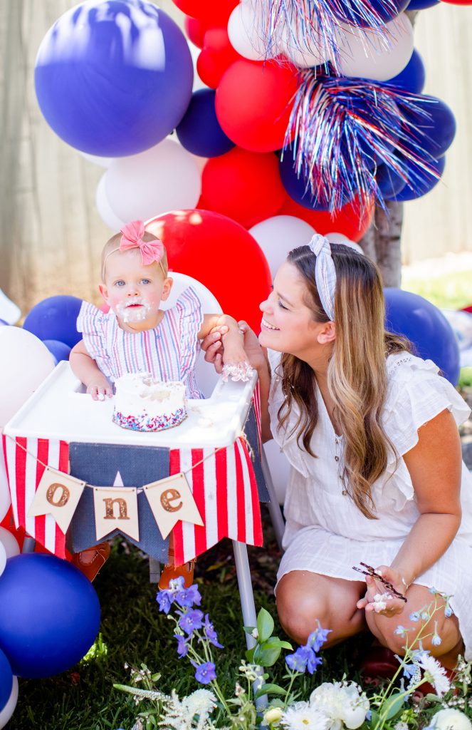 A red, white, and blue firework cake smash for a 4th of July baby