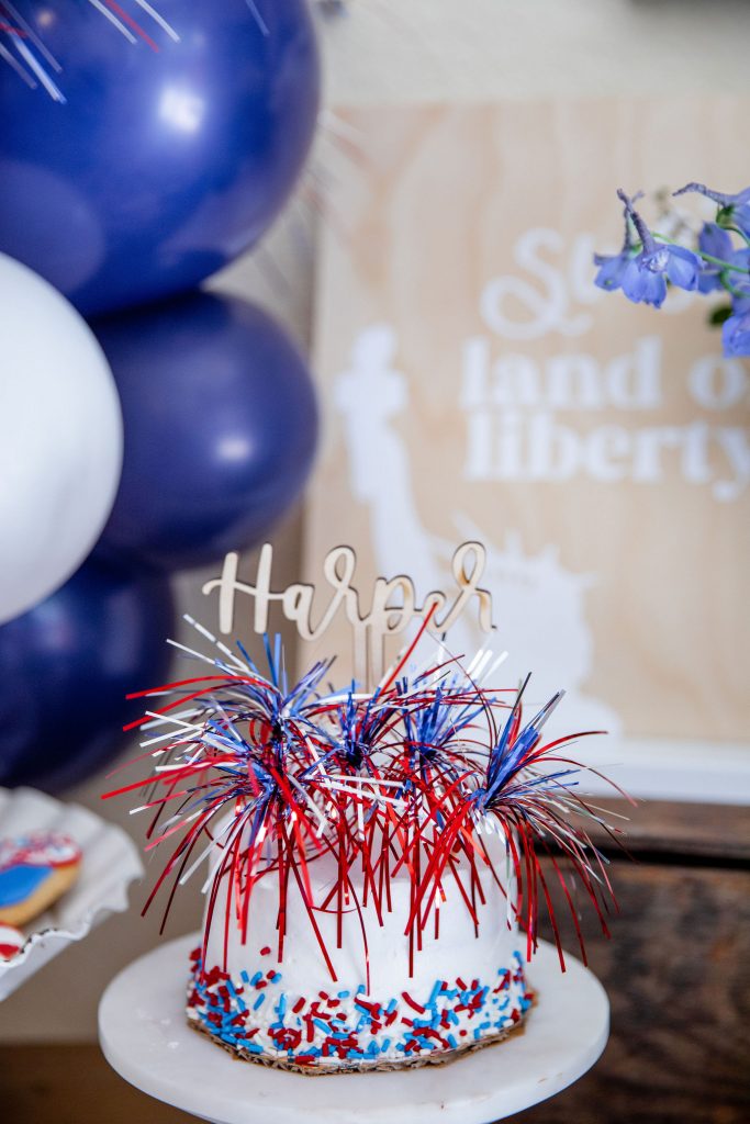 A red, white, and blue firework cake smash for a 4th of July baby